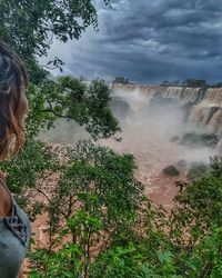 Woman looking at view of waterfall