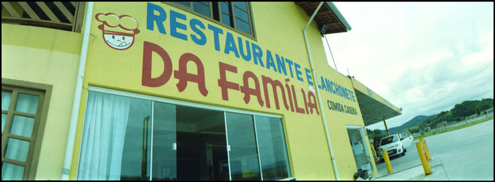 Low angle view of information sign against sky