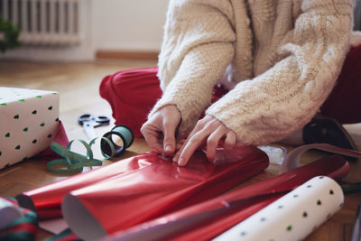 Woman's hands packing christmas presents