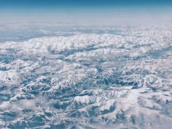 Aerial view of snow field against blue sky