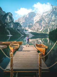 Rear view of man on lake against sky