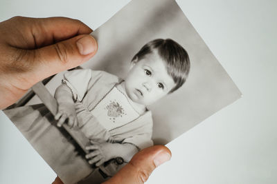 High angle portrait of smiling boy holding paper