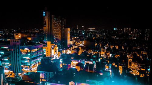 High angle view of illuminated city buildings at night