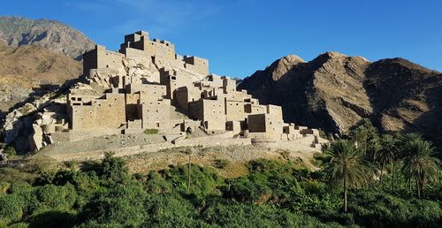 Low angle view of old buildings against blue sky