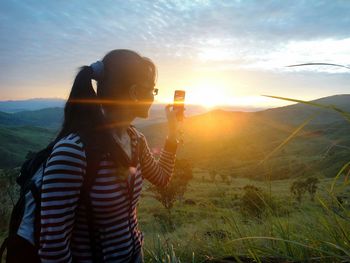 Rear view of man looking at sunset