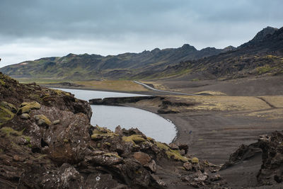 Scenic view of lake and mountains against sky