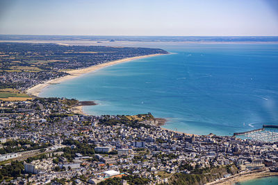 High angle view of buildings and sea against sky