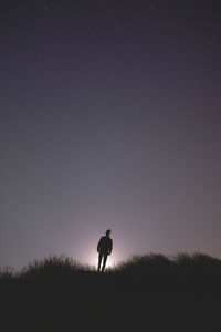 Silhouette men against sky at night