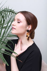 Portrait of young woman against white background
