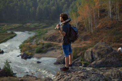 Side view of man standing on rock