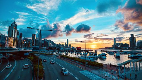 High angle view of street by buildings against sky during sunset