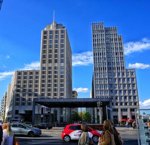 Low angle view of modern buildings against blue sky