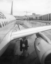 Airplane on airport runway against sky