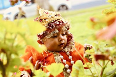 Baby boy wearing traditional clothing sofa at park