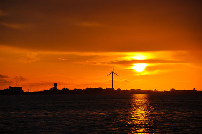 Silhouette of wind turbines at sunset