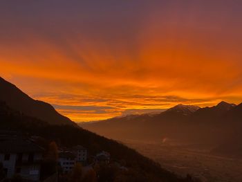 Scenic view of mountains against romantic sky at sunset