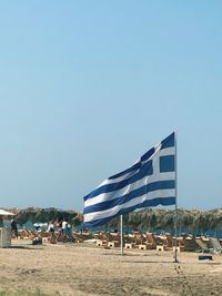 Built structure on beach against clear blue sky