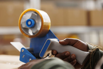 Cropped hand of woman holding equipment