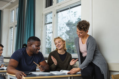 Female teacher helping student