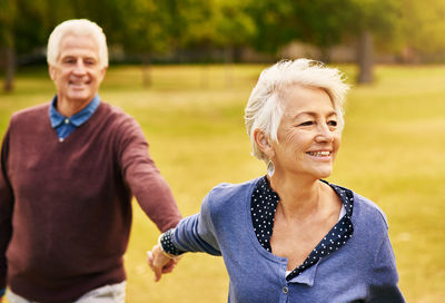 Senior couple holding hands at park