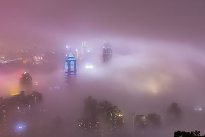 Aerial view of illuminated buildings in city at night