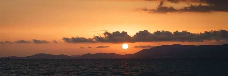 Scenic view of silhouette mountains against sky during sunset