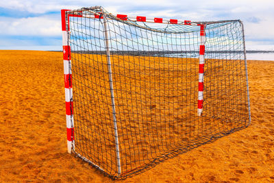 Soccer goal net on the beach in sunny day . football stadium at sandy coast