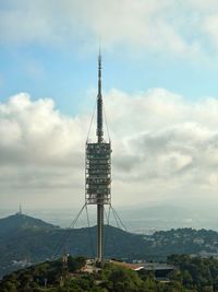 Communications tower and buildings against sky