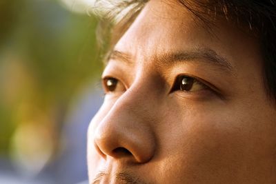 Close-up portrait of mid adult woman looking away