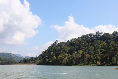 Scenic view of sea and mountains against sky