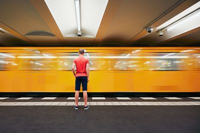 Rear view of woman standing in bus