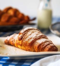 Close-up of croissant served in plate on table