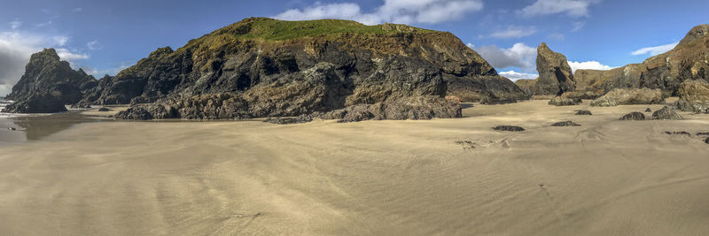 Panoramic view of rocks on land against sky