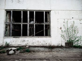 Broken window of abandoned house