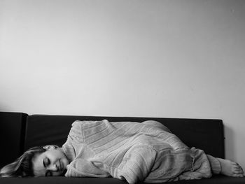 Young woman sleeping on sofa at home