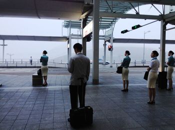 Rear view of people walking in airport