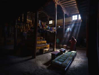 Man at illuminated market stall