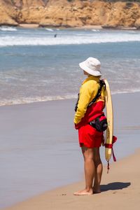 Rear view of boy walking on beach