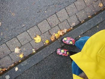 Low section of person standing on footpath