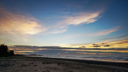 Scenic view of beach against sky during sunset
