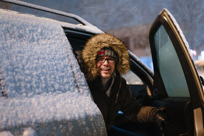 Portrait of man sitting in snow