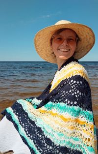 Portrait of smiling mid adult man at beach against sky