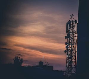 Low angle view of built structure against sunset sky