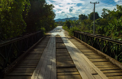 Timber jungle bridge in laos with forest either side