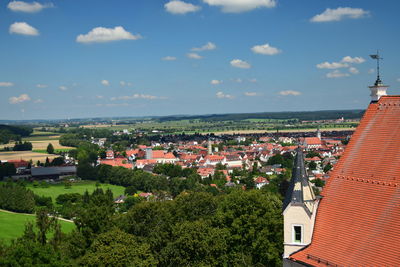 High angle view of houses in town against sky