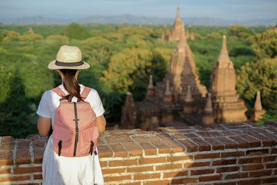 Woman standing against temples in city