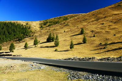 Scenic view of mountains against clear blue sky