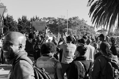 People in front of trees against sky