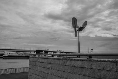 Railing by sea against sky