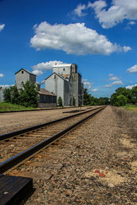 Surface level of railroad track against blue sky